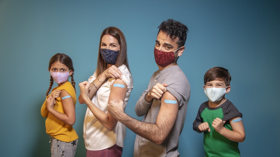 family smiling after receiving their flu shot