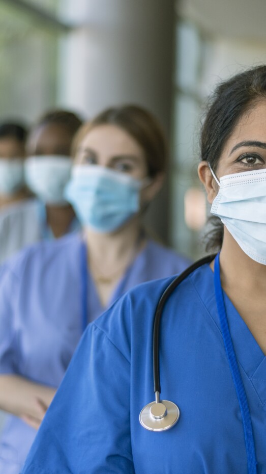 female doctor leading team of medical professionals